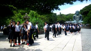 many students taking selfies in front of great buddha